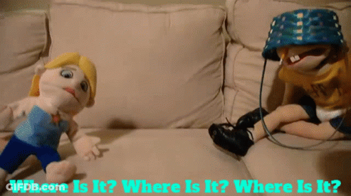 Two Stuffed Dolls Are Sitting On A Couch With The Words Where Is It GIF