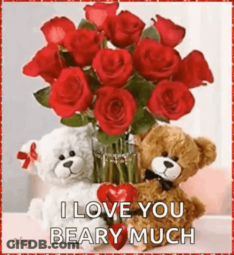 Two Teddy Bears Beside Vase Of Red Roses And Heart GIF