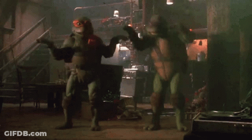 Two Teenage Mutant Ninja Turtles In Dark Room GIF