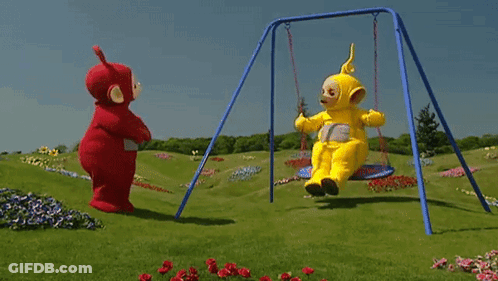 Two Teletubbies Are Swinging On A Swing Set In A Grassy Field GIF