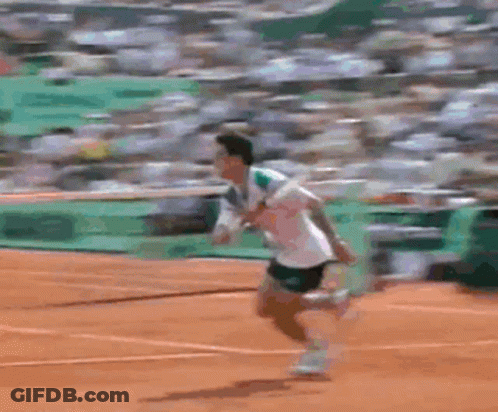 Two Tennis Players Are Playing On A Court With A Green Wall Behind Them That Says ' Lacoste ' GIF