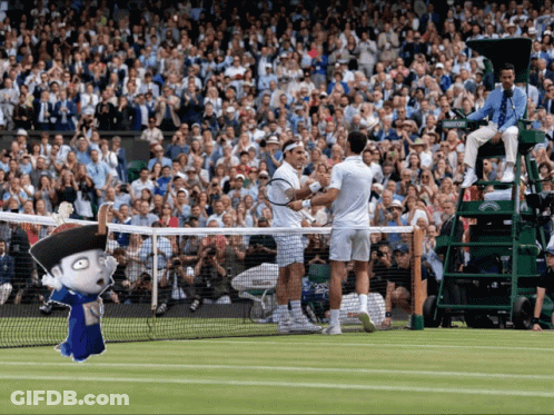 Two Tennis Players Are Shaking Hands On A Court With A Crowd Watching GIF
