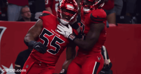 Two Texans Players Are Hugging Each Other GIF