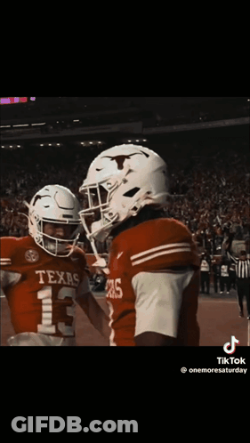 Two Texas Football Players Hugging GIF