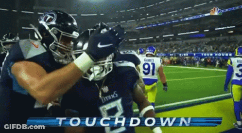 Two Titans Football Players Hugging On Field GIF