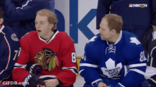 Two Toronto Maple Leafs Players Sitting On The Bench GIF