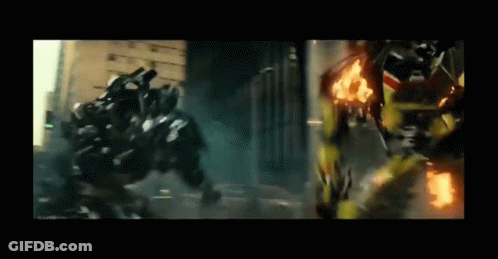 Two Transformers Are Fighting Each Other In A City While A Car Is On Fire . GIF