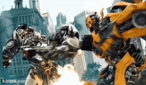 Two Transformers Fighting In Front Of City With Umedia GIF