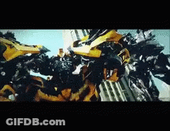 Two Transformers Fighting Yellow One GIF