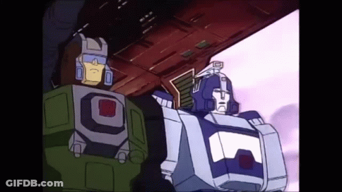 Two Transformers Standing Together GIF