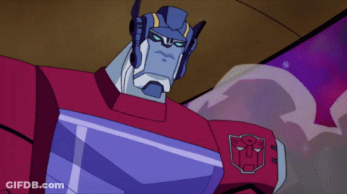 Two Transformers Standing Together One With Chest Shield GIF