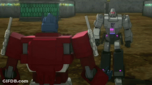 Two Transformers Standing With Text And Now Look At This Server GIF