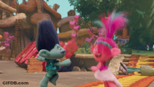 Two Trolls Dancing In Front Of A Sign That Says ' Trolls ' On It GIF