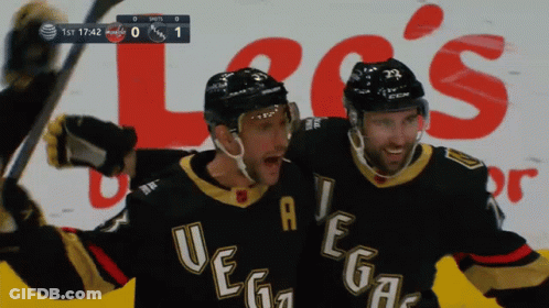 Two Vegas Hockey Players Celebrate A Goal In Front Of An Advertisement For Lee 'S GIF