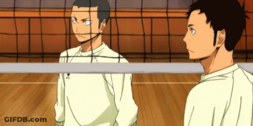 Two Volleyball Players Are Standing Next To Each Other On A Court . GIF