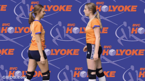 Two Volleyball Players Holding Hands In Front Of A Holyoke Background GIF