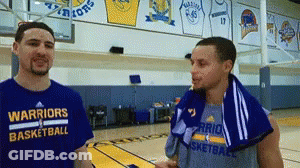 Two Warriors Basketball Players Are Talking On A Court GIF