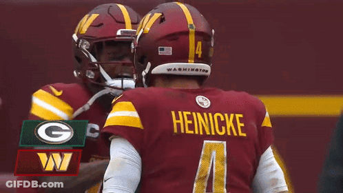 Two Washington Redskins Players Are Hugging Each Other During A Fox NFL Game GIF