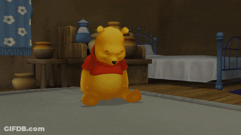 Two Winnie The Pooh Bears Are Standing Next To Each Other On A Bed GIF