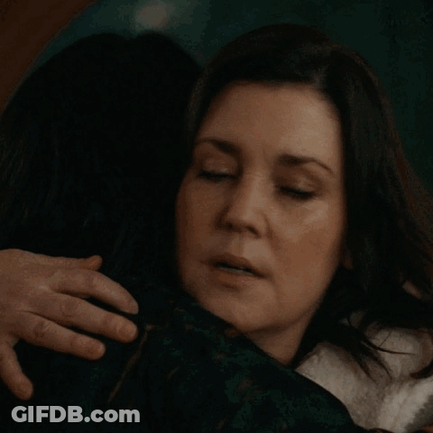 Two Wolves Hugging One Looking At Camera GIF