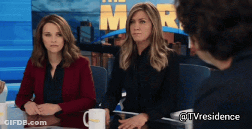Two Women And Man At Table With Mr. Sign GIF