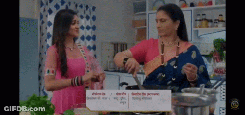 Two Women Are Cooking In A Kitchen With A Sign That Says ' Cooking ' GIF