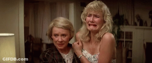 Two Women Are Crying In A Living Room . GIF
