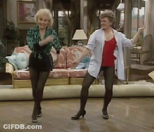 Two Women Are Dancing In A Living Room . GIF
