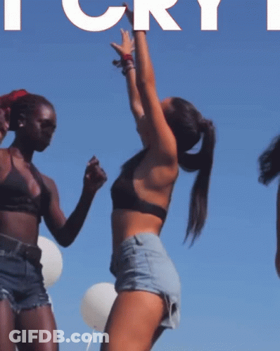 Two Women Are Dancing In Front Of A Blue Sky With The Word Cry In White GIF
