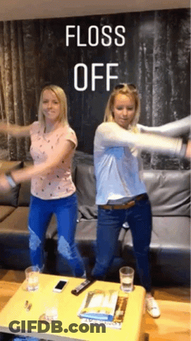 Two Women Are Dancing In Front Of A Couch With The Words Floss Off Written Above Them GIF