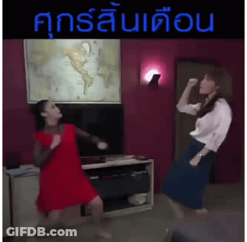 Two Women Are Dancing In Front Of A Map Of The World In A Living Room .. GIF