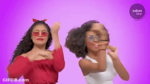 Two Women Are Dancing In Front Of A Purple Background With A Salon Line Logo In The Corner GIF