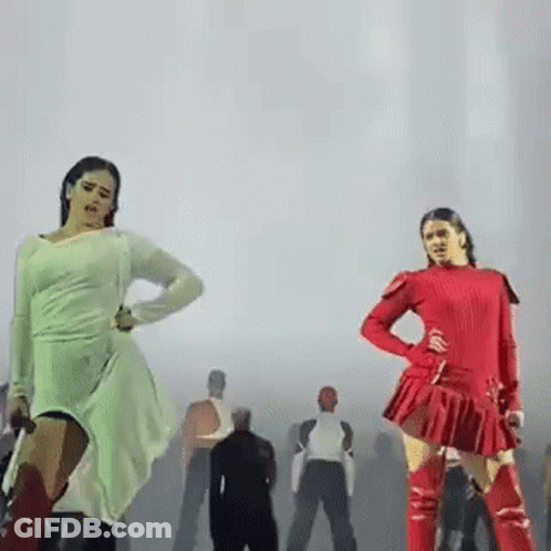 Two Women Are Dancing On A Stage In Front Of A Group Of People . GIF
