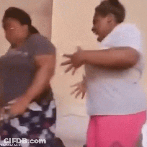 Two Women Are Dancing Together In A Room And One Of Them Is Laughing . GIF