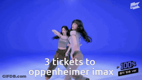 Two Women Are Dancing With The Words 3 Tickets To Oppenheimer Imax Behind Them GIF