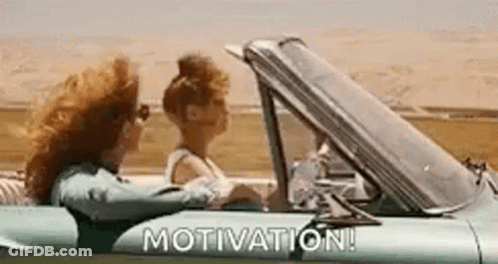 Two Women Are Driving A Car With The Words `` Motivation '' Written On It . GIF