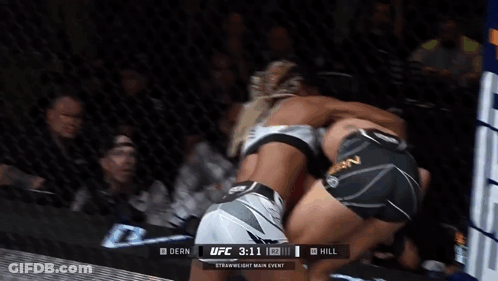 Two Women Are Fighting In A Boxing Ring With The Ufc 3:11 In The Corner GIF