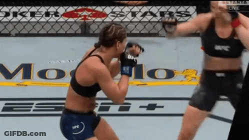 Two Women Are Fighting In A Ring With A Sign That Says Joker Stars GIF