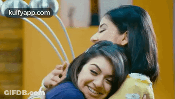 Two Women Are Hugging Each Other In A Room And The Words Kulfyapp.com Are Visible In The Corner . GIF