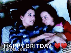 Two Women Are Hugging Each Other In Bed With The Words Happy Britday Written Above Them . GIF