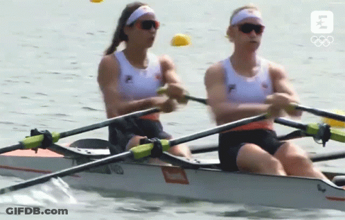 Two Women Are In A Rowing Boat With The Letter B On The Bottom GIF
