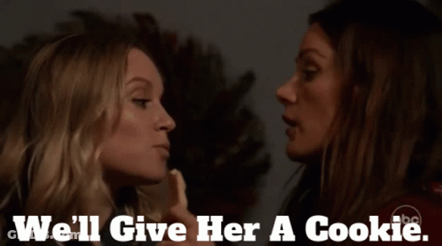 Two Women Are Kissing With The Words " We 'Ll Give Her A Cookie " On The Bottom GIF