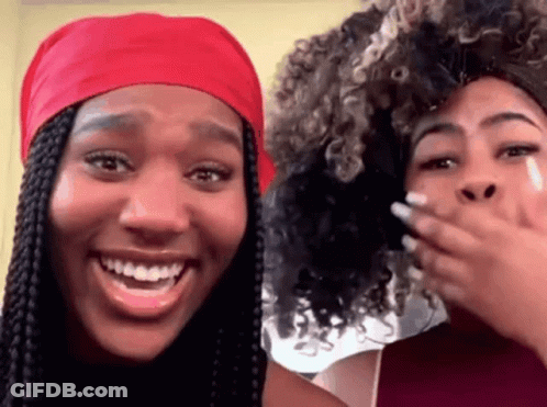 Two Women Are Laughing And One Has A Red Headband On GIF