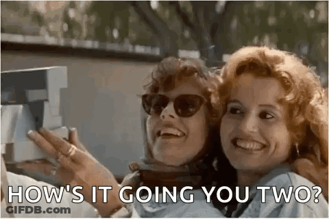 Two Women Are Laughing And Taking A Picture With A Camera . GIF