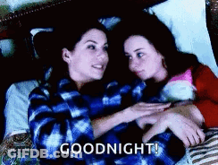 Two Women Are Laying In Bed Hugging Each Other And The Words `` Goodnight '' Are Written On The Bottom . GIF