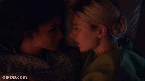 Two Women Are Laying Next To Each Other And One Has A Star On Her Face GIF