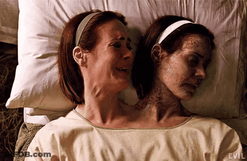 Two Women Are Laying Next To Each Other In A Hospital Bed . One Of The Women Has Two Heads . GIF