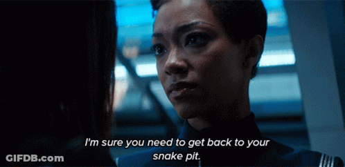 Two Women Are Looking At Each Other And One Of Them Is Saying I 'M Sure You Need To Get Back To Your Snake Pit GIF