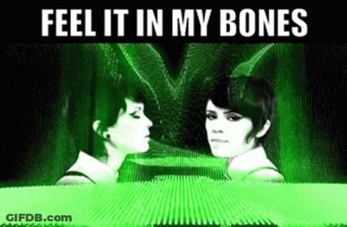 Two Women Are Looking At Each Other With The Words Feel It In My Bones Above Them GIF
