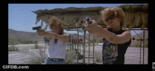 Two Women Are Pointing Their Guns At Each Other In A Movie GIF